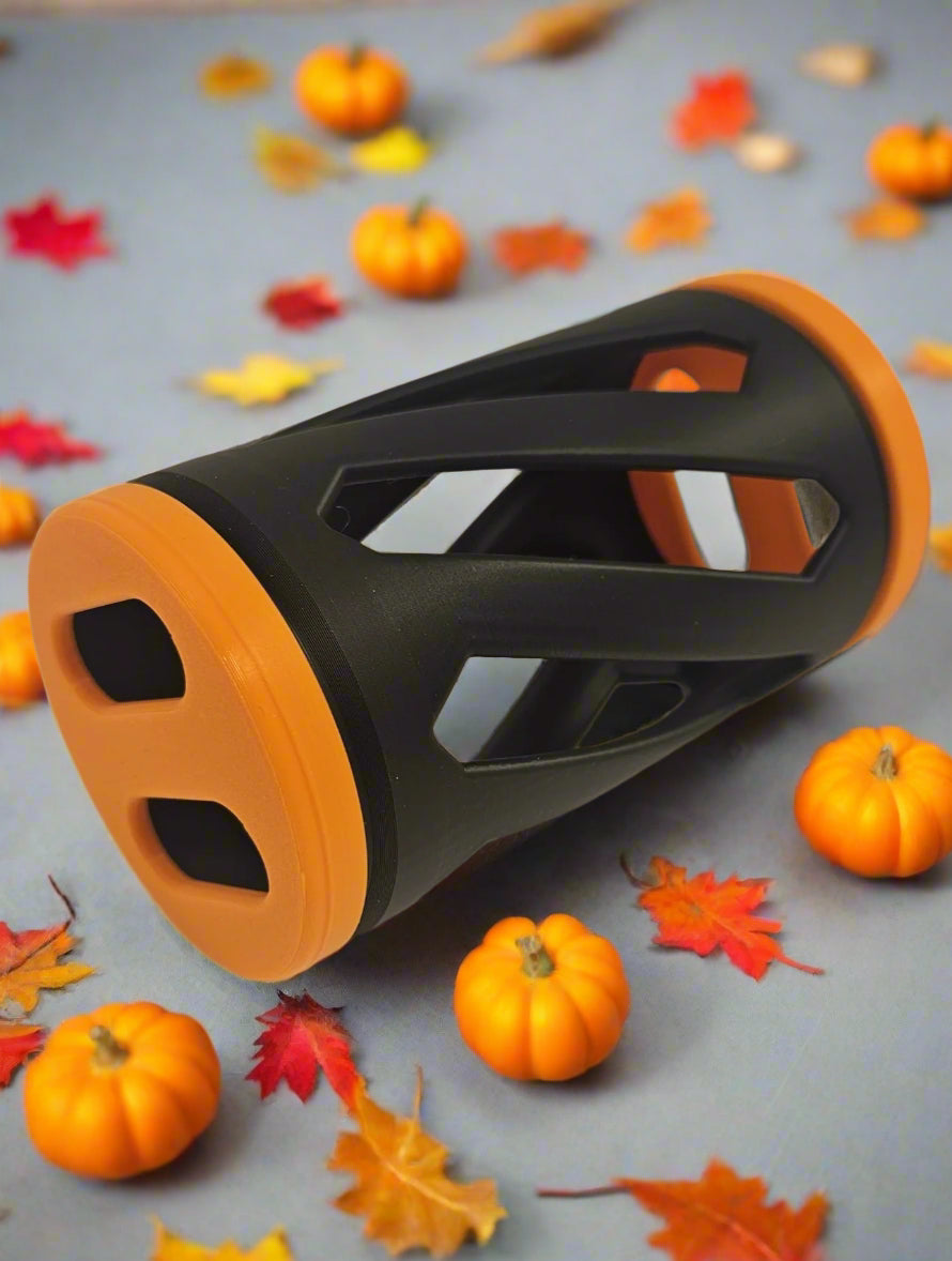 Black and orange rabbit hay roller toy against an autumn background