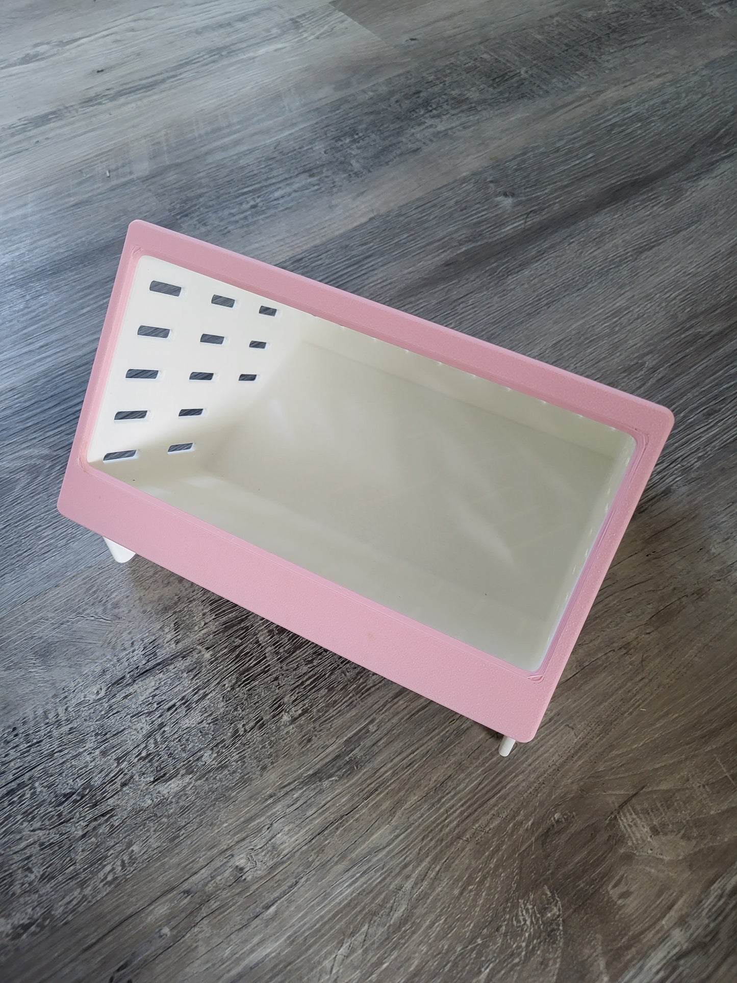 White 3D printed hay feeder with pink front with easy-fill top opening for small pets