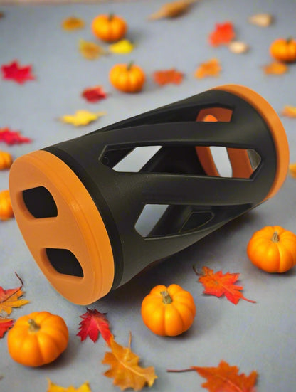 Black and orange rabbit hay roller toy against an autumn background