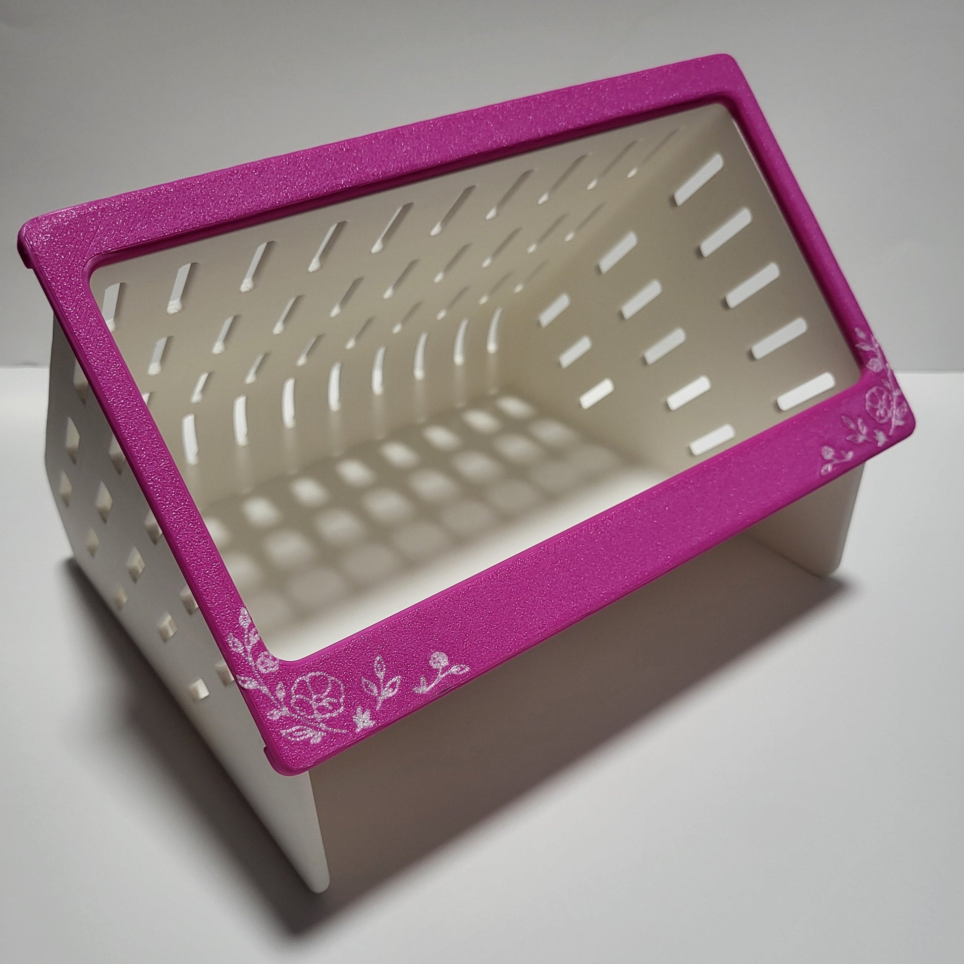 open air hay feeder with a hot pink and white floral design faceplate