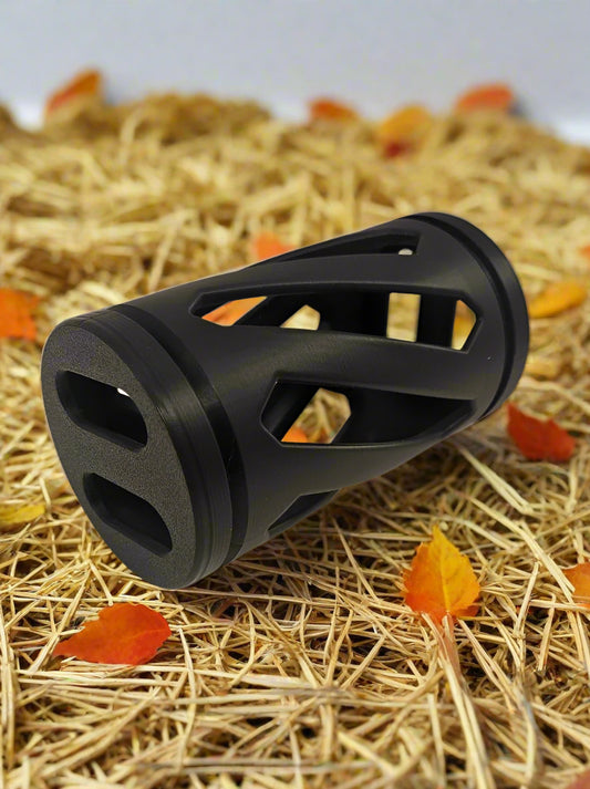 Black rabbit hay roller toy against an autumn background