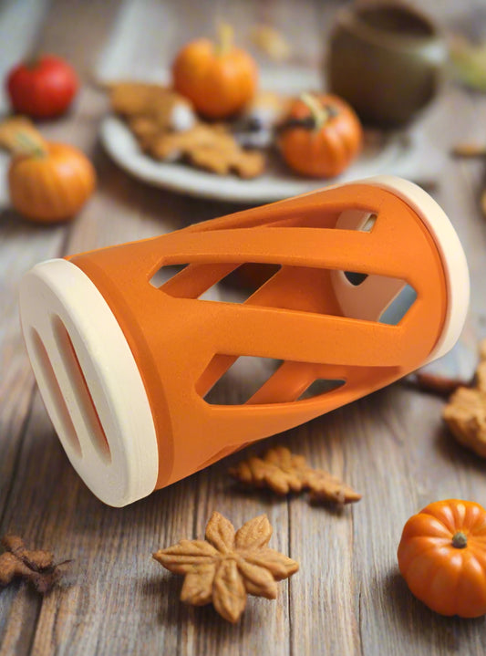 White and orange rabbit hay roller toy against an autumn background
