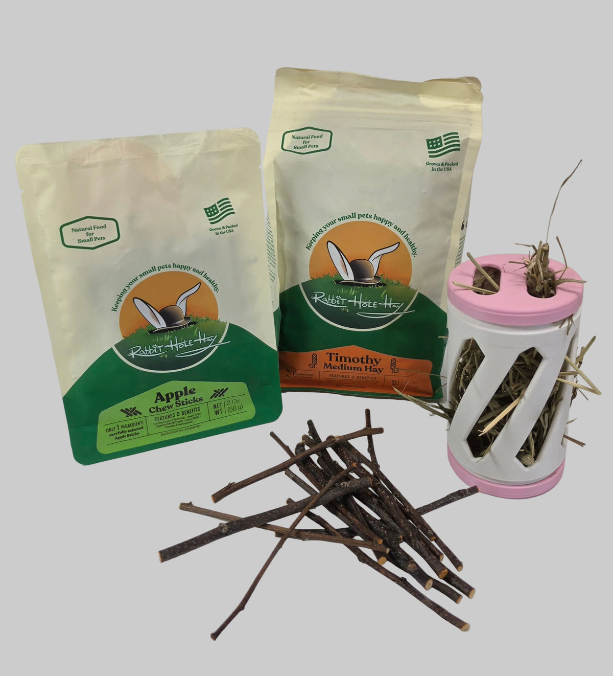 a bag of apple chew sticks and a bag of hay with a hay roller against a white background