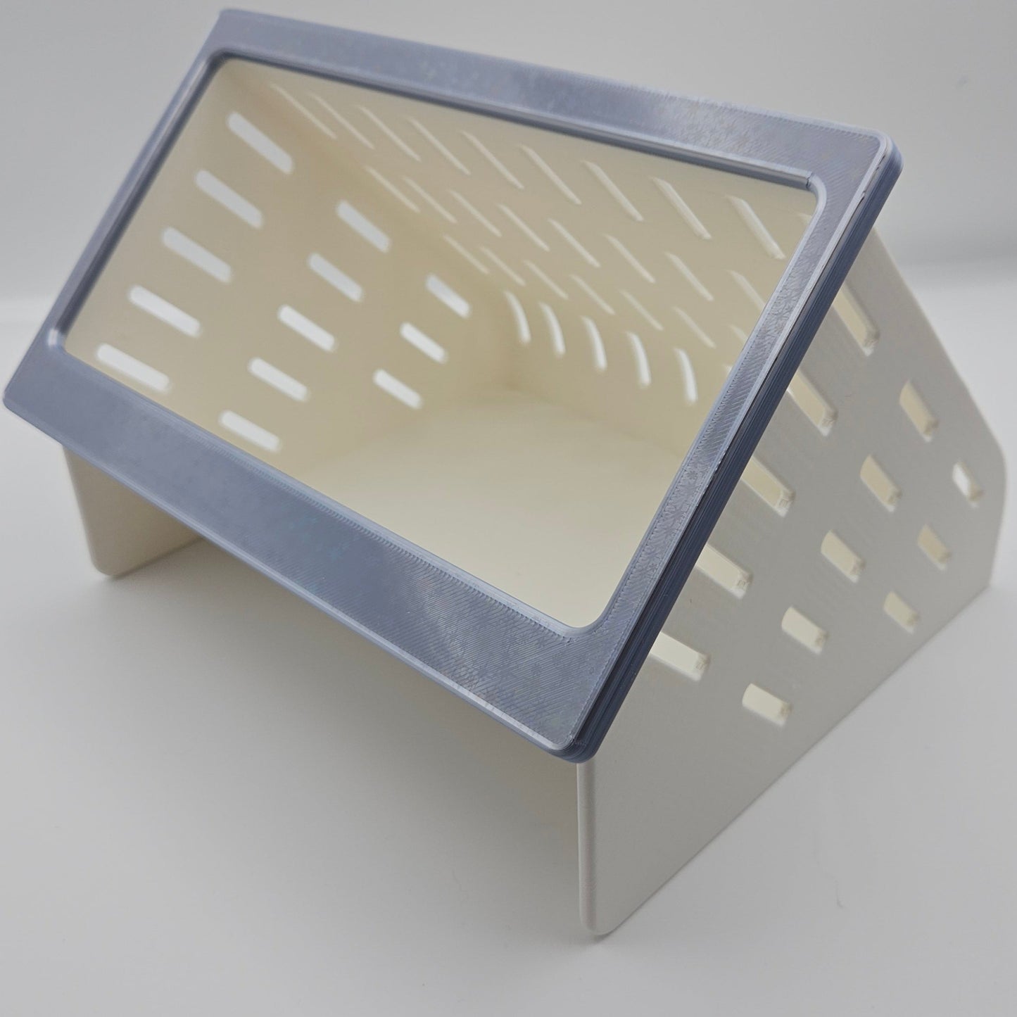 a silver and white hay feeder for rabbits