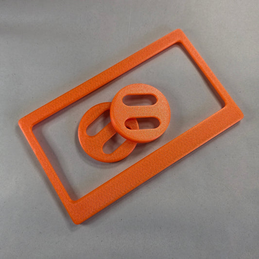 Rescue Friday Marigold Faceplate and Roller Lid Bundle — Autumn 2026. Both pieces in warm shimmery marigold orange.